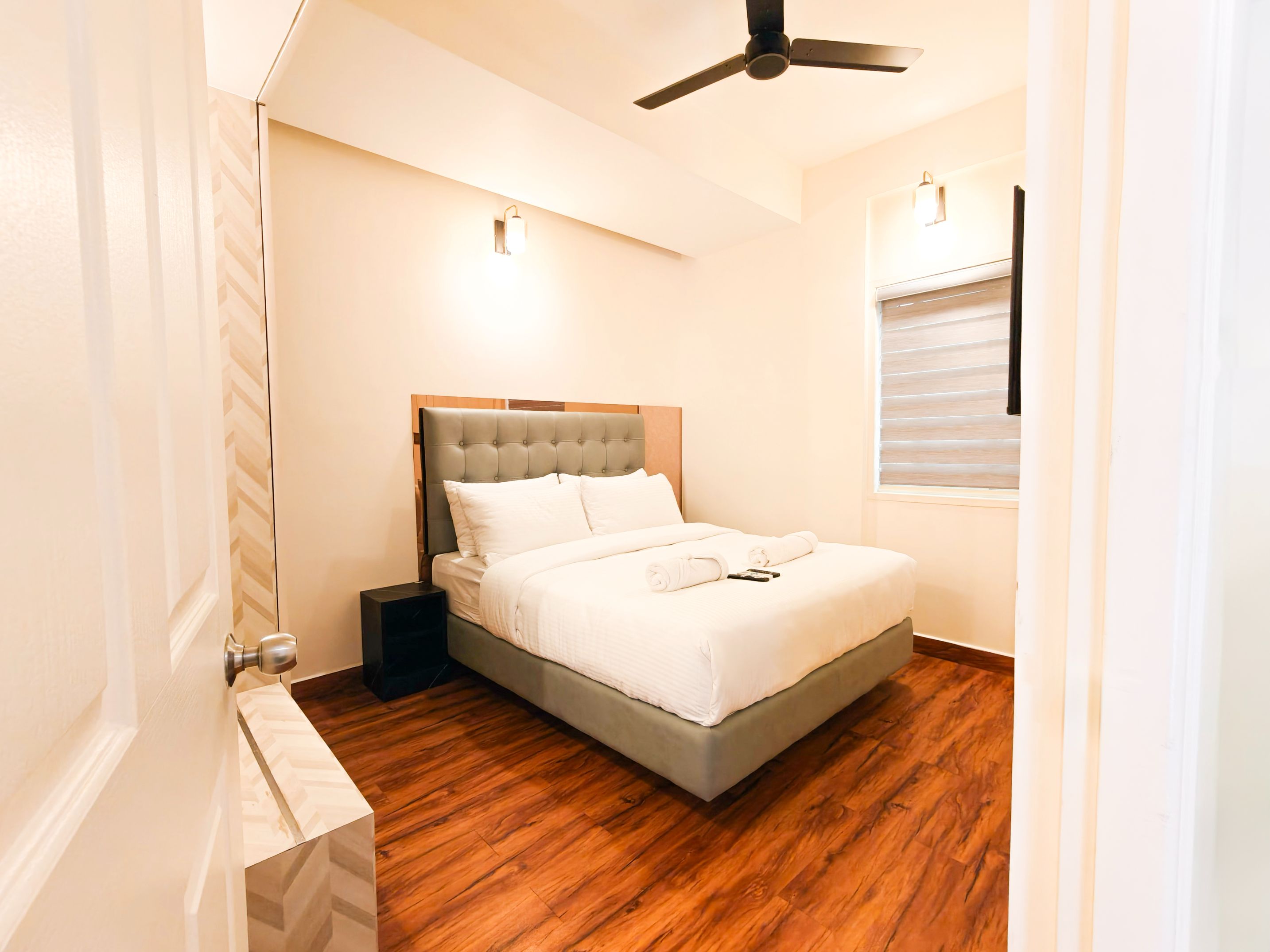 Luxurious Luxos apartment with premium furnishings, wooden flooring, elegant beige walls, and pristine white bedding